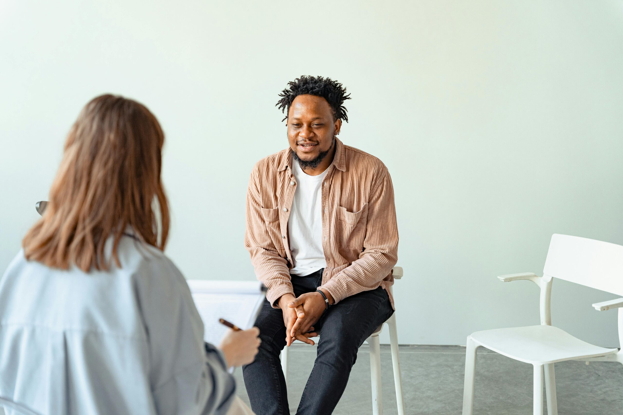 Man smiling while talking to a specialist
